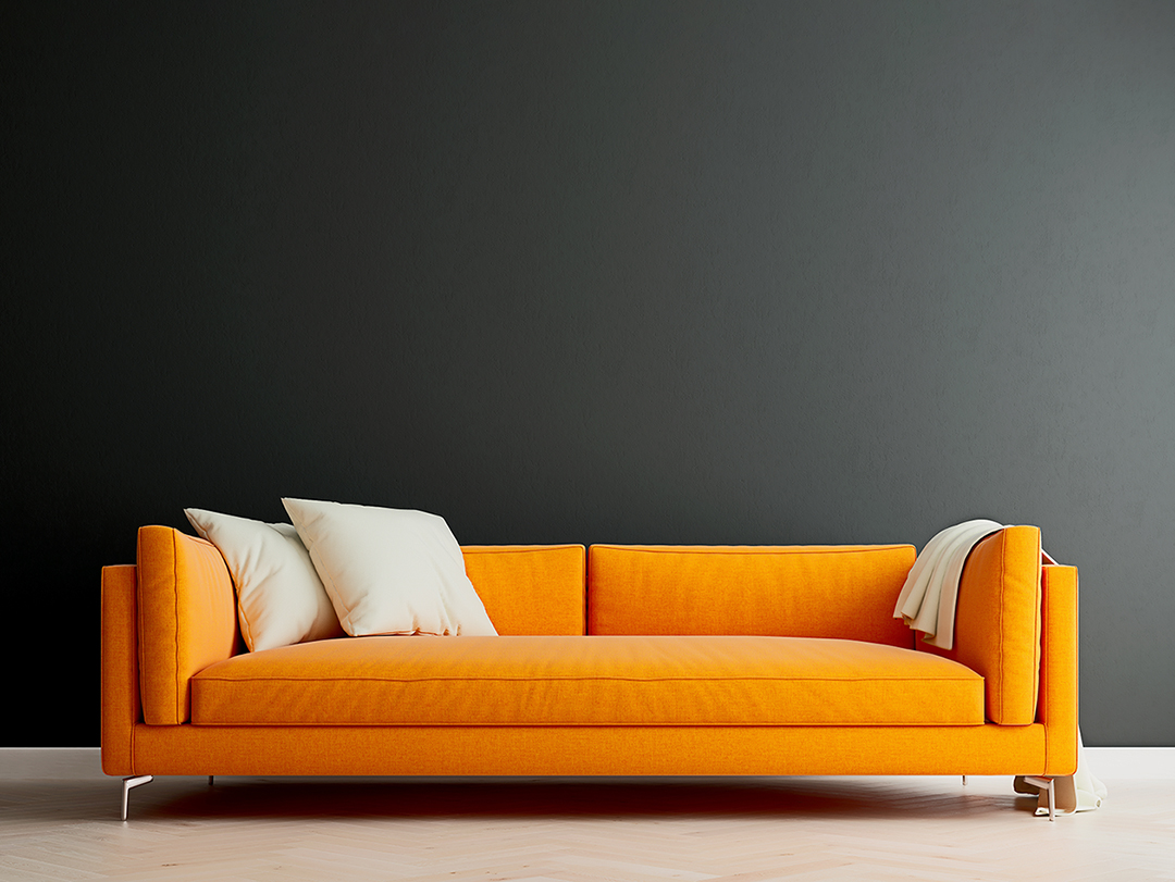 Black mock up wall with orange sofa in modern interior backgroun